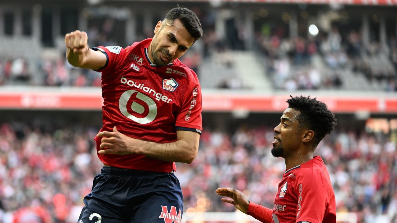 Lille's Turkish defender Zeki Celik (L) celebrates after scoring during the French L1 football match between Lille LOSC and Strasbourg RC at the Pierre-Mauroy Stadium in Villeneuve-d'Ascq, northern France on April 24, 2022.