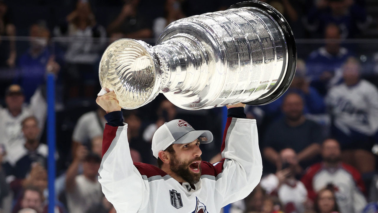 TAMPA, FLORIDA - JUNE 26: Andrew Cogliano #11 of the Colorado Avalanche lifts the Stanley Cup after defeating the Tampa Bay Lightning 2-1 in Game Six of the 2022 NHL Stanley Cup Final at Amalie Arena on June 26, 2022 in Tampa, Florida.