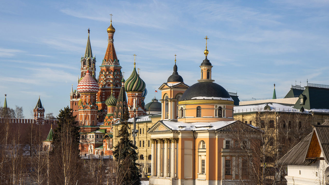 Visitors walk through Zaryadye Park in view of Saint Basil's Cathedral in Moscow, Russia, on Tuesday, Feb. 15, 2022. Russia announced the start of a pullback of some forces after drills that raised U.S. and European alarm about a possible military assault on Ukraine. Photographer: Andrey Rudakov/Bloomberg via Getty Images