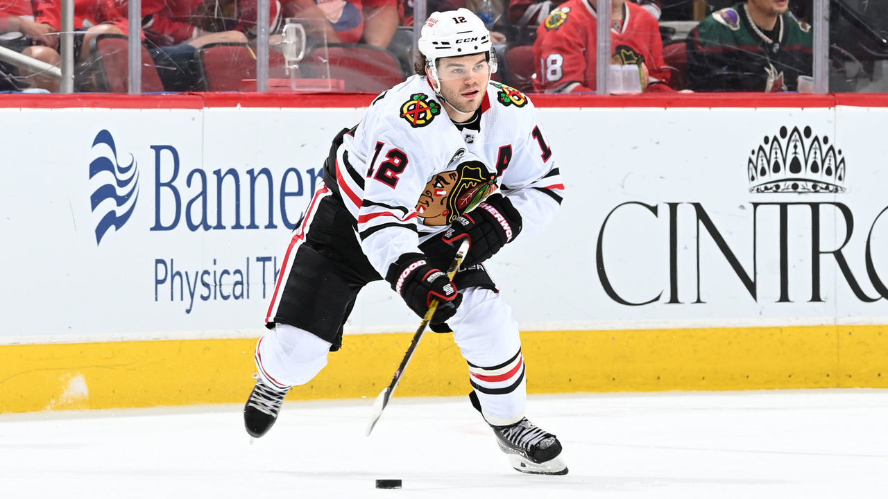 GLENDALE, ARIZONA - APRIL 20: Alex DeBrincat #12 of the Chicago Blackhawks skates with the puck against the Arizona Coyotes at Gila River Arena on April 20, 2022 in Glendale, Arizona.