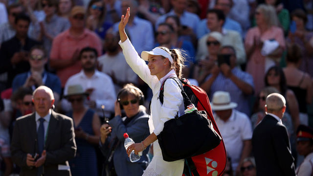 LONDON, ENGLAND - JULY 07: Match winner Elena Rybakina of Kazakhstan waves to the crowd as they walk of the court following victory against Simona Halep of Romania after their Women's Singles Semi-Final match on day eleven of The Championships Wimbledon 2022 at All England Lawn Tennis and Croquet Club on July 07, 2022 in London, England.