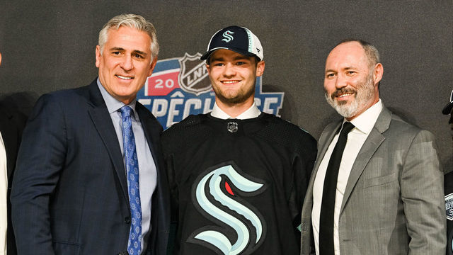 MONTREAL, QC - JULY 07: Seattle Kraken pick Shane Wright stands between management during the first round of the 2022 NHL Entry Draft on July 07, 2022 at Bell Centre in Montreal, QC