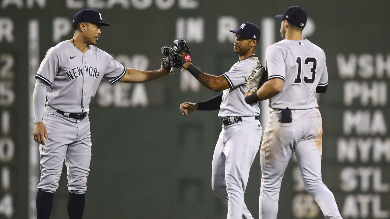 BOSTON, MA - JULY 07: Giancarlo Stanton #27, Aaron Hicks #31 and Joey Gallo #13 of the New York Yankees high five after a victory over the Boston Red Sox at Fenway Park on July 7, 2022 in Boston, Massachusetts.