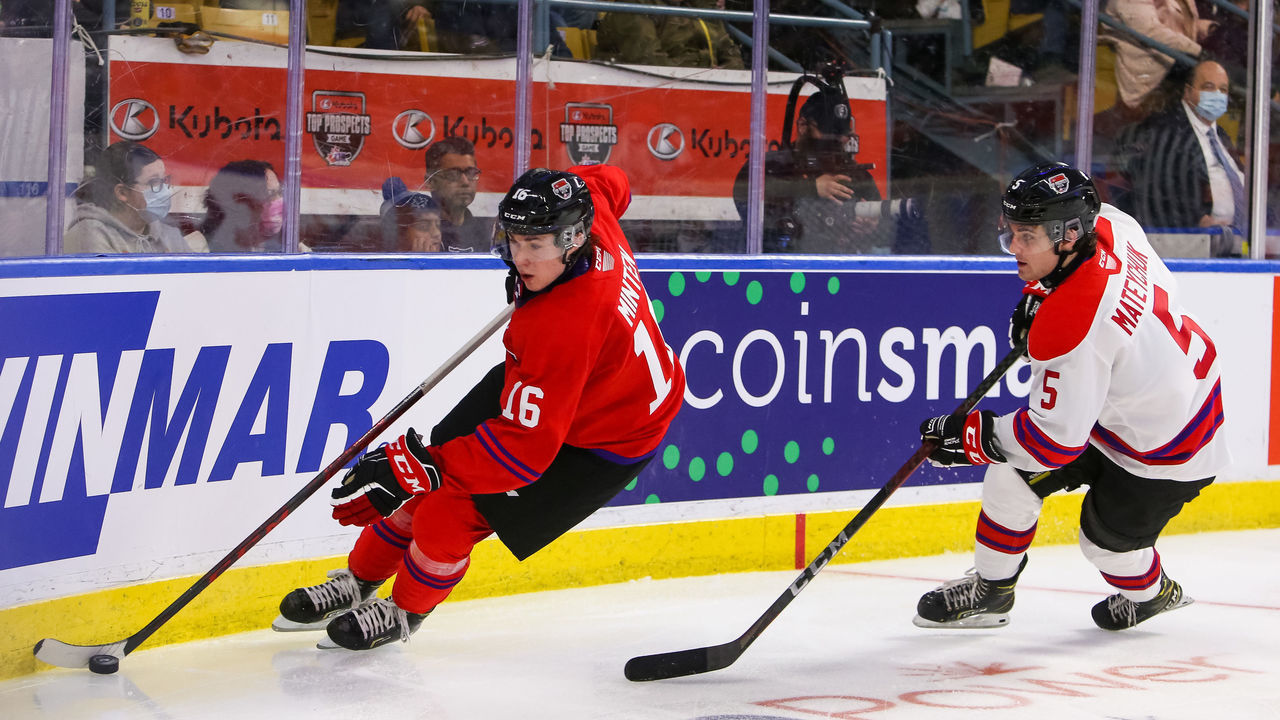 KITCHENER, ONTARIO - MARCH 23: Fraser Minten #16 of Team Red protects the puck from Denton Mateychuk #5 of Team White in the 2022 CHL/NHL Top Prospects Game at Kitchener Memorial Auditorium on March 23, 2022 in Kitchener, Ontario.