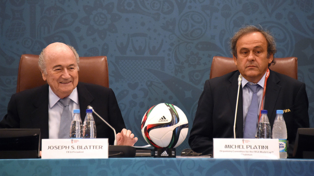 FIFA President Joseph Blatter (L) smiles as he sits next to UEFA President Michel Platini (R) as they join a seminar ahead of the Preliminary Draw for the FIFA World Cup 2018, in St.Petersburg, Russia, 25 July 2015. Photo: MARCUS BRANDT/dpa | usage worldwide