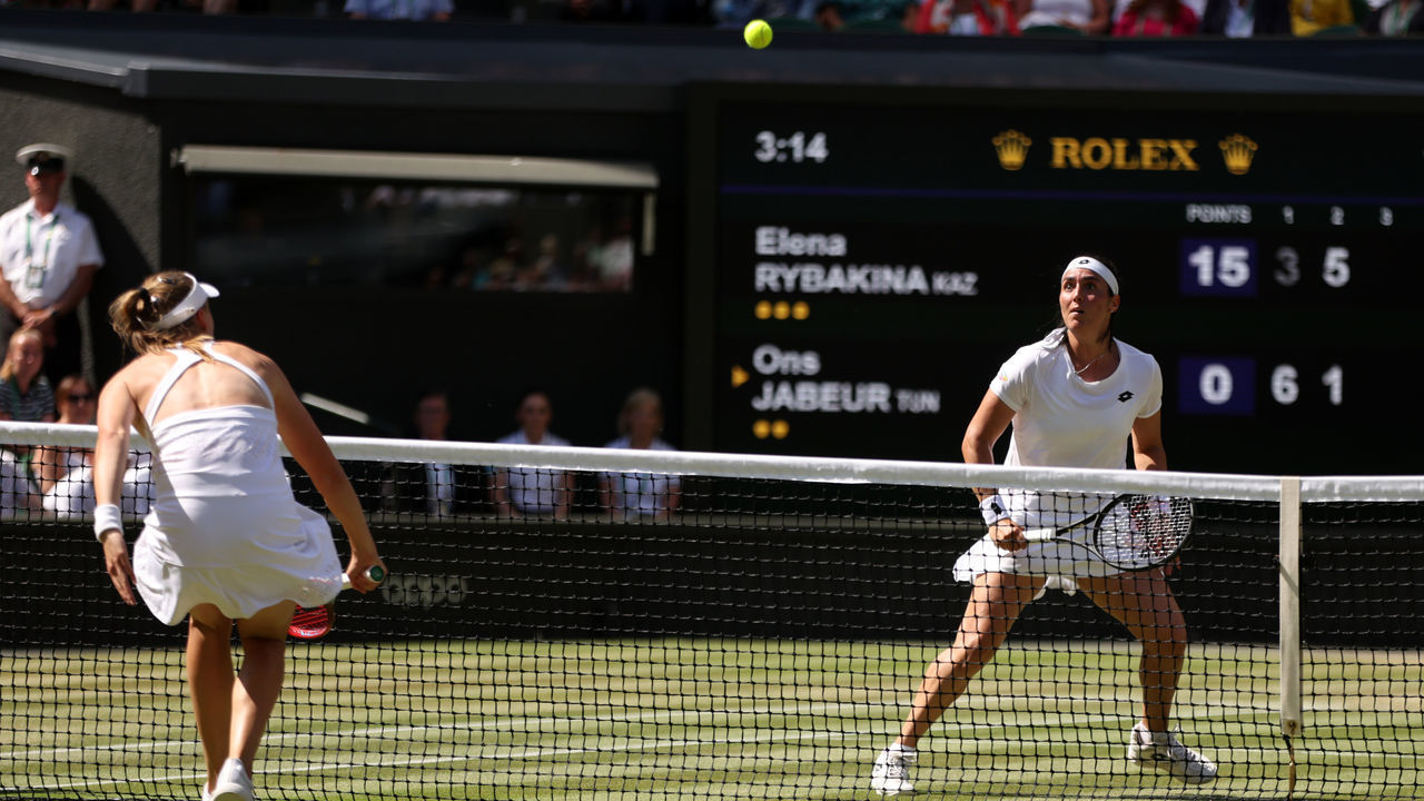 LONDON, ENGLAND - JULY 09: Elena Rybakina of Kazakhstan plays a backhand against Ons Jabeur of Tunisia during the Ladies' Singles Final match on day thirteen of The Championships Wimbledon 2022 at All England Lawn Tennis and Croquet Club on July 09, 2022 in London, England.