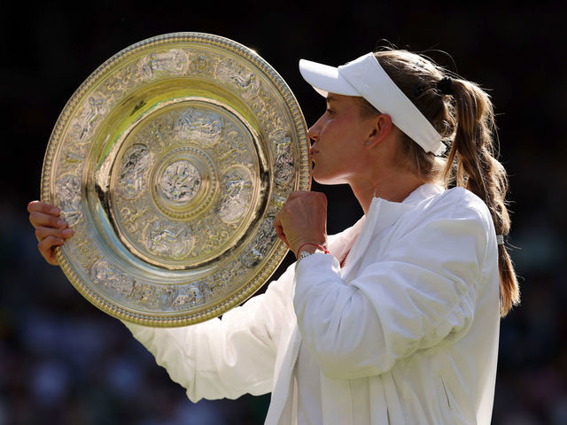 LONDON, ENGLAND - JULY 09: Elena Rybakina of Kazakhstan kisses the trophy after victory against Ons Jabeur of Tunisia during the Ladies' Singles Final match on day thirteen of The Championships Wimbledon 2022 at All England Lawn Tennis and Croquet Club on July 09, 2022 in London, England.