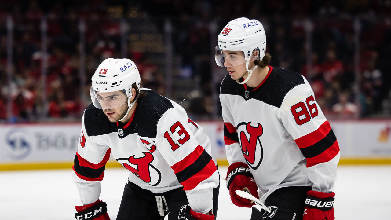 WASHINGTON, DC - March 26: Nico Hischier #13 and Jack Hughes #86 of the New Jersey Devils prepare for a face-off against the Washington Capitals during the first period of the game at Capital One Arena on March 26, 2022 in Washington, DC.