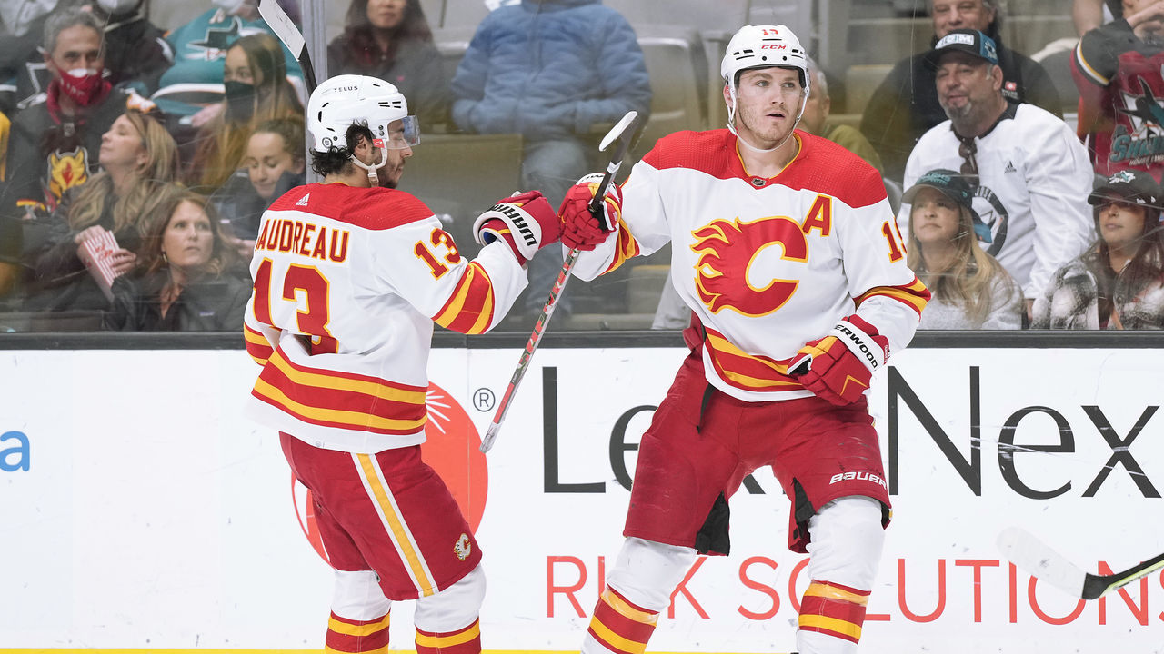 SAN JOSE, CALIFORNIA - APRIL 07: Matthew Tkachuk #19 of the Calgary Flames is congratulated by Johnny Gaudreau #13 after scoring a goal against the San Jose Sharks during the first period of an NHL hockey game at SAP Center on April 07, 2022 in San Jose, California.