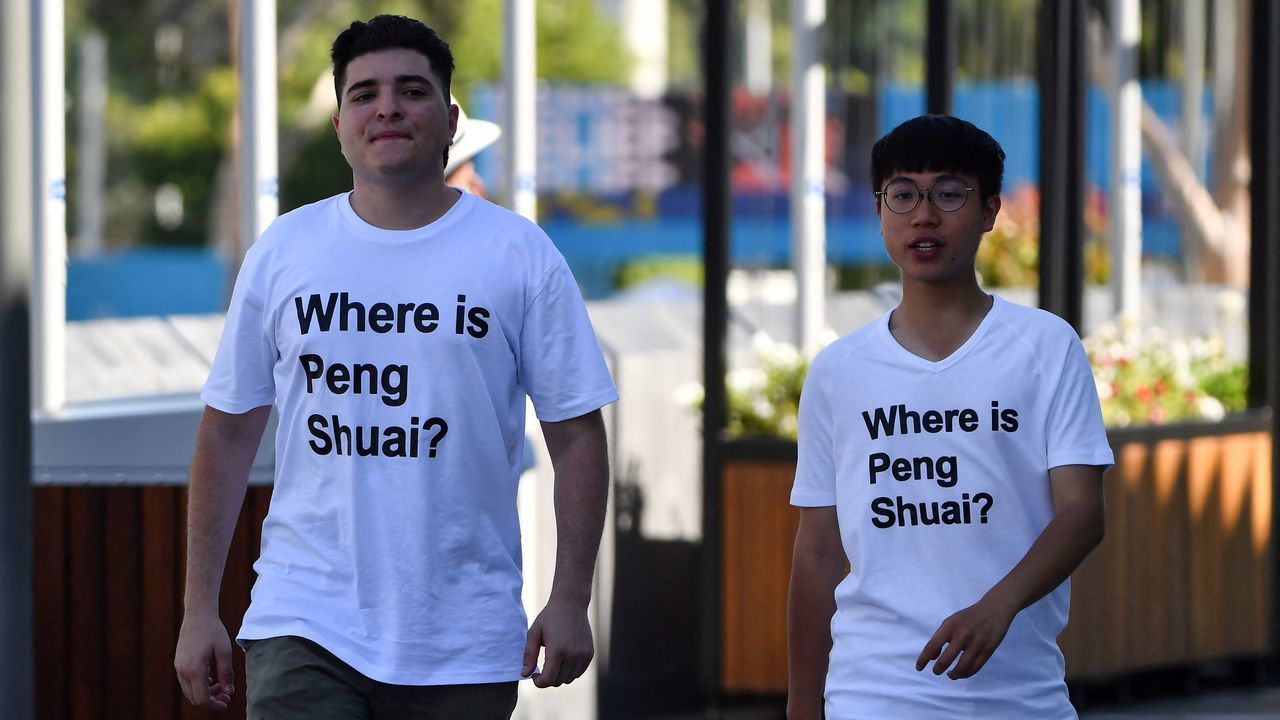 Australian human rights campaigner Drew Pavlou (L) is pictured wearing a "Where is Peng Shuai?" T-shirt, referring to the former doubles world number one from China, on the grounds outside one of the venues on day nine of the Australian Open tennis tournament in Melbourne on January 25, 2022. - -- IMAGE RESTRICTED TO EDITORIAL USE - STRICTLY NO COMMERCIAL USE --