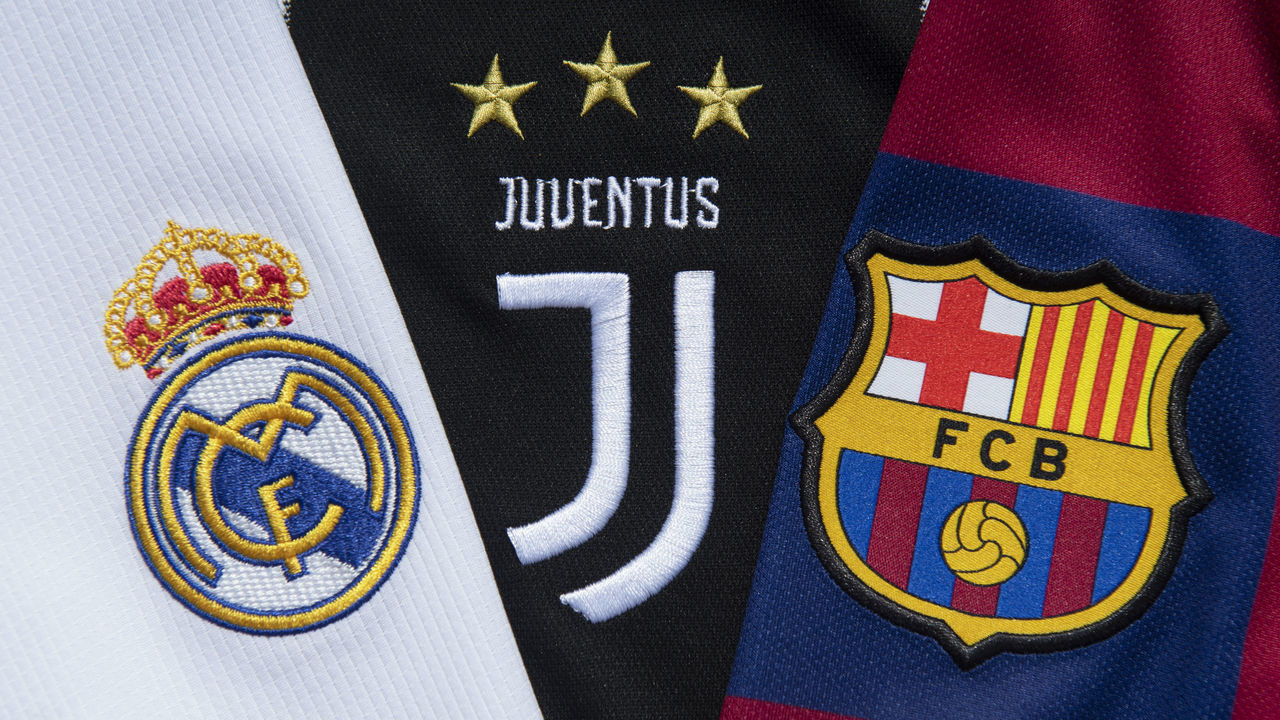 MANCHESTER, ENGLAND - MAY 10: The club badges of the three remaining clubs in the European Super League Real Madrid, Juventus and Barcelona on their first team home shirts on May 10, 2021 in Manchester, United Kingdom.