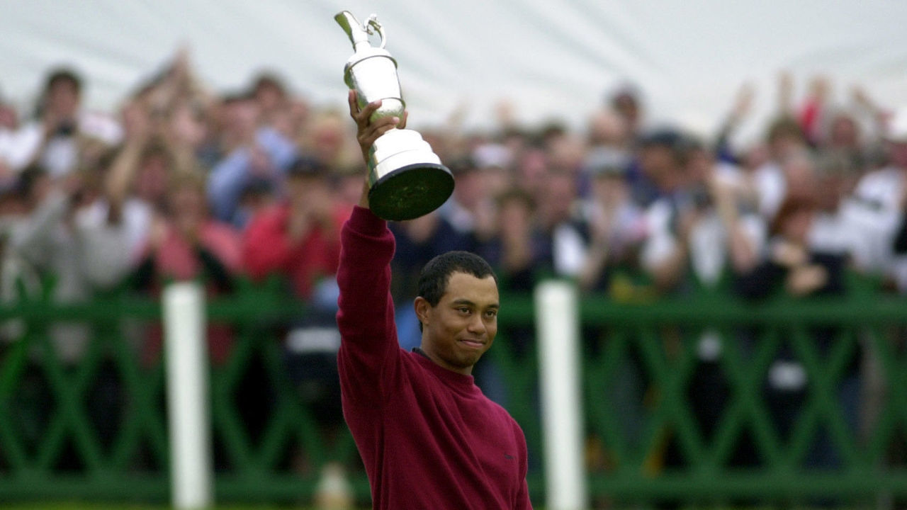 Tiger Woods holds the Claret Jug aloft after winning the Open golf championship with a final score of 19 under par at St. Andrews, Scotland.