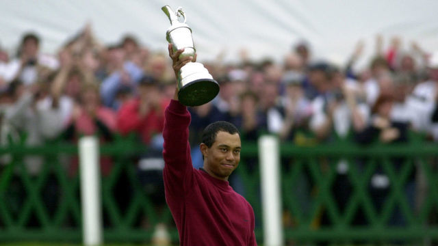 Tiger Woods holds the Claret Jug aloft after winning the Open golf championship with a final score of 19 under par at St. Andrews, Scotland.