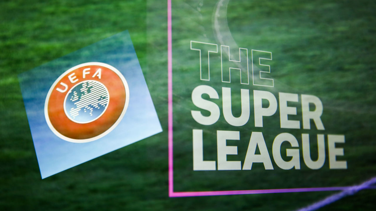 UEFA logo displayed on a phone screen and The Super League logo displayed on a screen are seen in this multiple exposure illustration photo taken in Krakow, Poland on April 20, 2021. (Photo Illustration by Jakub Porzycki/NurPhoto via Getty Images)
