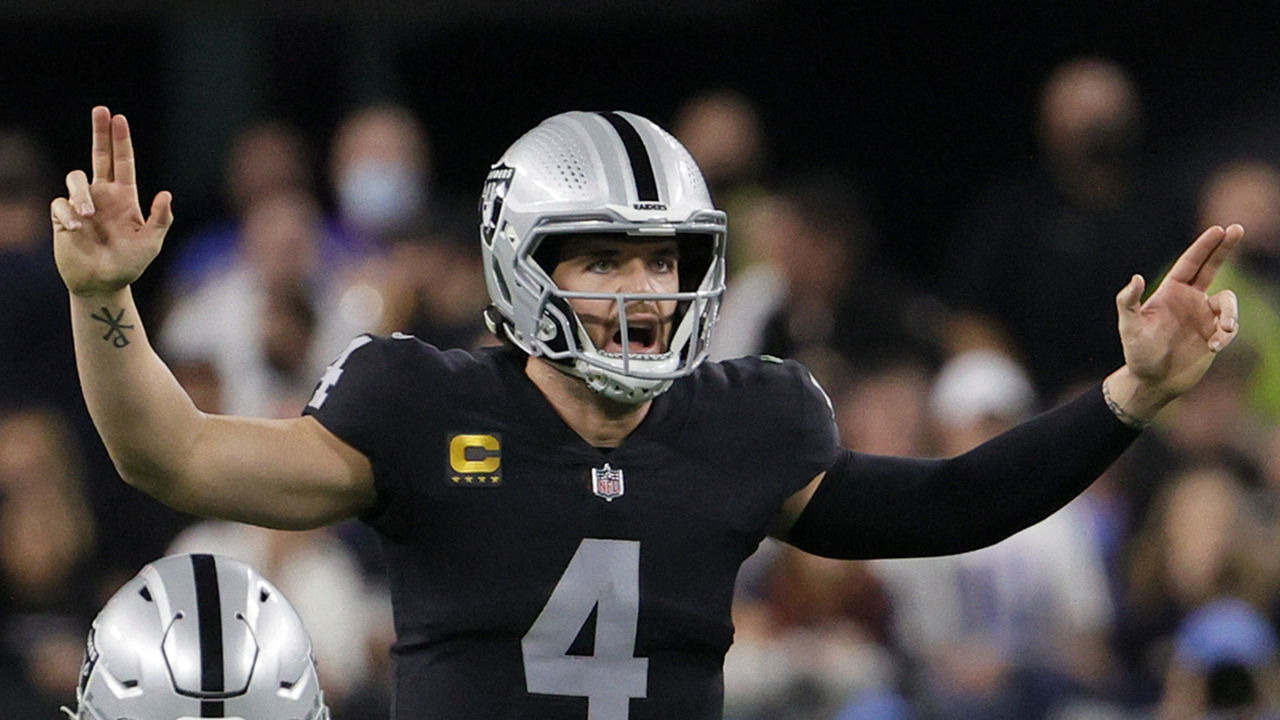 LAS VEGAS, NEVADA - JANUARY 09: Quarterback Derek Carr #4 of the Las Vegas Raiders gestures behind guard Alex Leatherwood #70 at the line of scrimmage during their game against the Los Angeles Chargers at Allegiant Stadium on January 9, 2022 in Las Vegas, Nevada. The Raiders defeated the Chargers 35-32 in overtime.