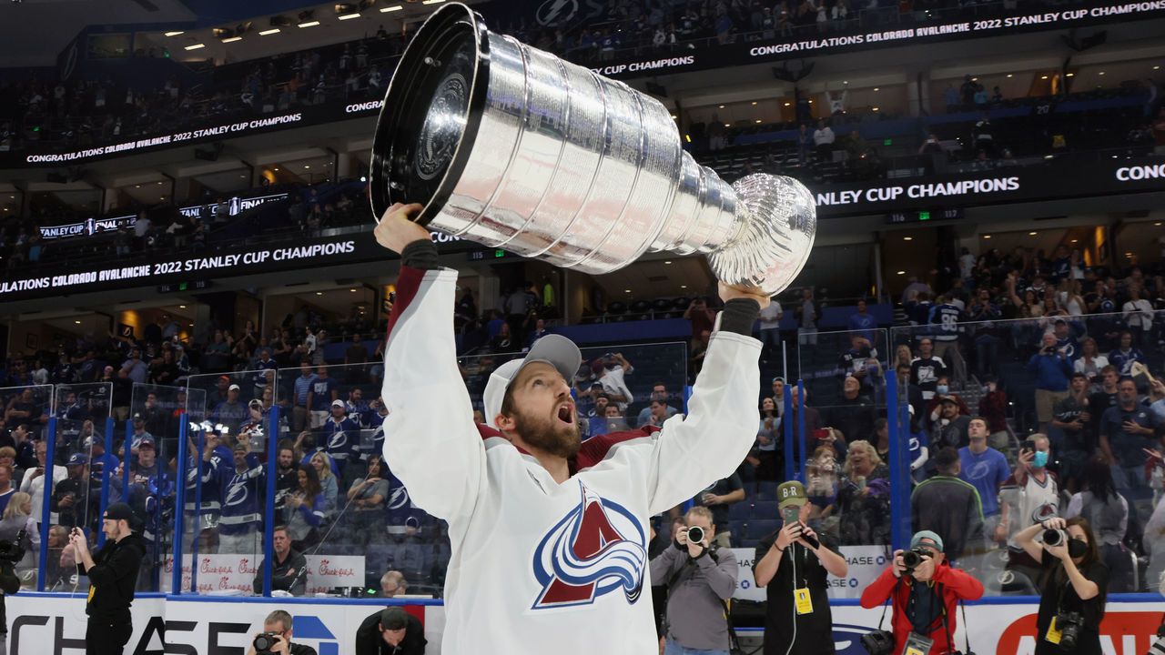TAMPA, FLORIDA - JUNE 26: Darren Helm #43 of the Colorado Avalanche carries the Stanley Cup following the series winning victory over the Tampa Bay Lightning in Game Six of the 2022 NHL Stanley Cup Final at Amalie Arena on June 26, 2022 in Tampa, Florida.