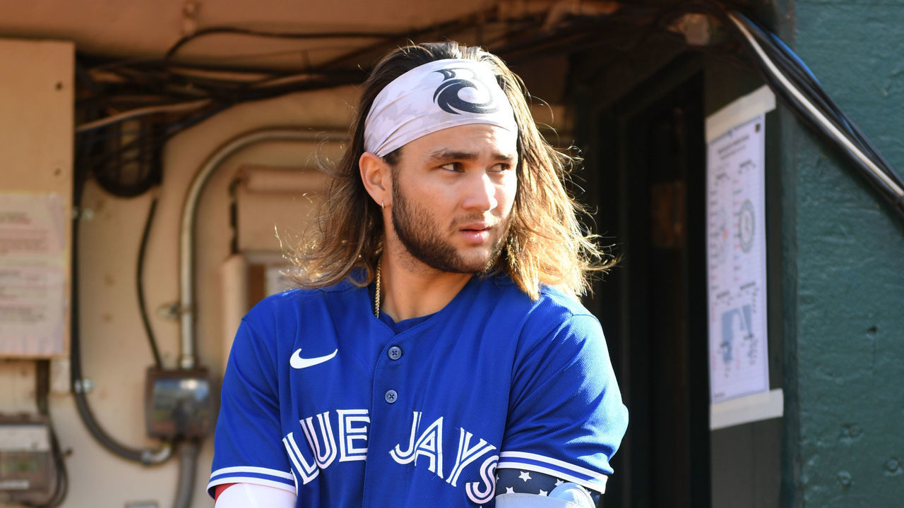 OAKLAND, CALIFORNIA - JULY 04: Bo Bichette #11 of the Toronto Blue Jays puts his batting glove on in the dugout during pregame as they face the Oakland Athletics at RingCentral Coliseum on July 04, 2022 in Oakland, California.
