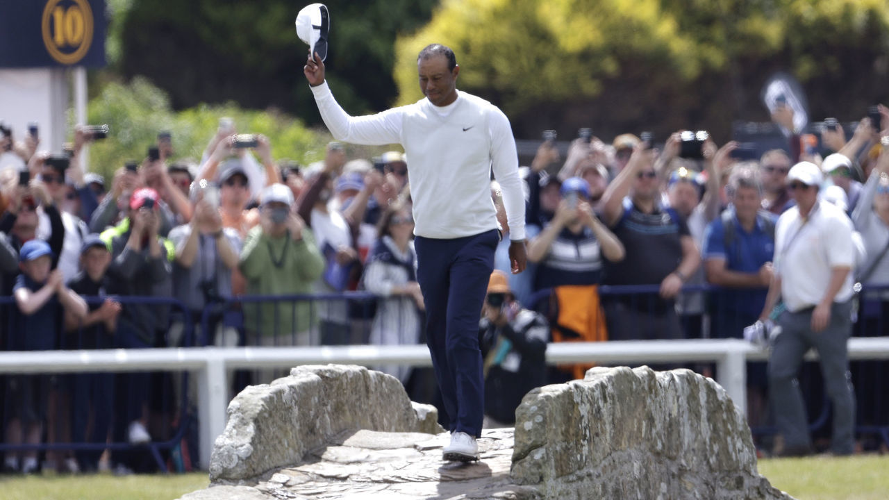USA's Tiger Woods waves to the crowd as he goes over the Swilcan Bridge on the 18th during day two of The Open at the Old Course, St Andrews. Picture date: Friday July 15, 2022.