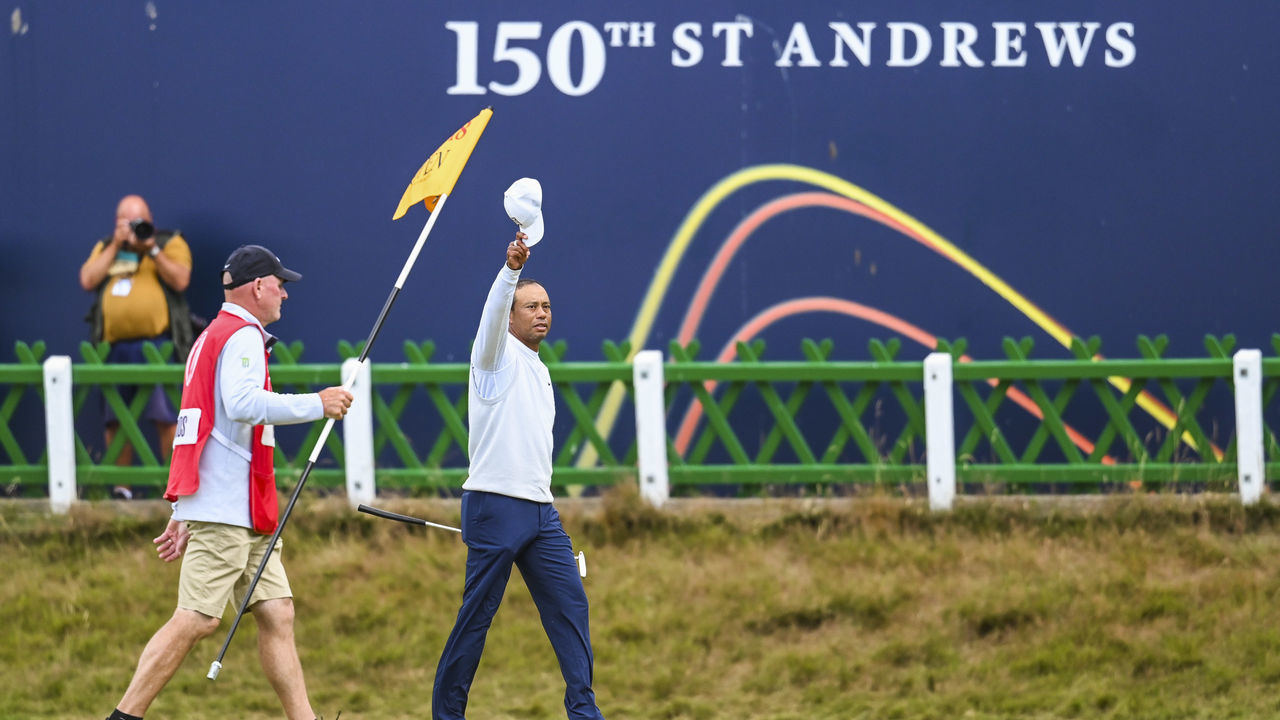 ST ANDREWS, SCOTLAND - JULY 15: Tiger Woods waves his hat to fans after completing play on the 18th hole green during the second round of The 150th Open Championship on The Old Course at St Andrews on July 15, 2022 in St. Andrews, Scotland.