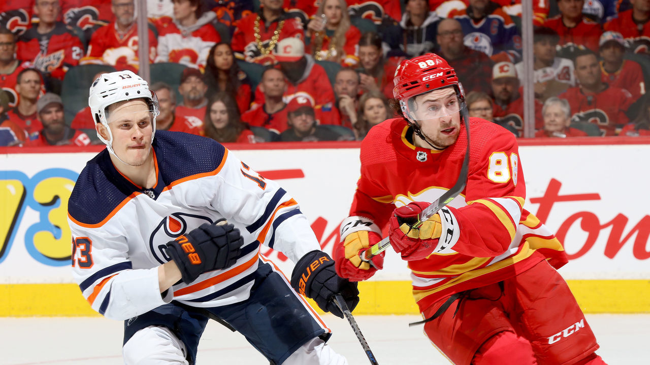CALGARY, ALBERTA - MAY 18: Andrew Mangiapane #88 of the Calgary Flames skates against Jesse Puljujarvi #13 of the Edmonton Oilers in Game One of the Second Round of the 2022 Stanley Cup Playoffs at Scotiabank Saddledome on May 18, 2022 in Calgary, Alberta.
