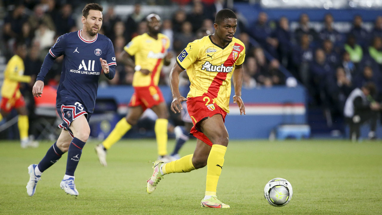 PARIS, FRANCE - APRIL 23: Cheick Doucoure of Lens, Lionel Messi of PSG (left) during the Ligue 1 Uber Eats match between Paris Saint-Germain (PSG) and RC Lens (RCL) at Parc des Princes stadium on April 23, 2022 in Paris, France.