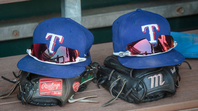 KANSAS CITY, MO - JUNE 29: Texas Rangers hats sit on the bench prior to the game between the Kansas City Royals and the Texas Rangers on June 29th at Kauffman Stadium in Kansas City, Missouri.