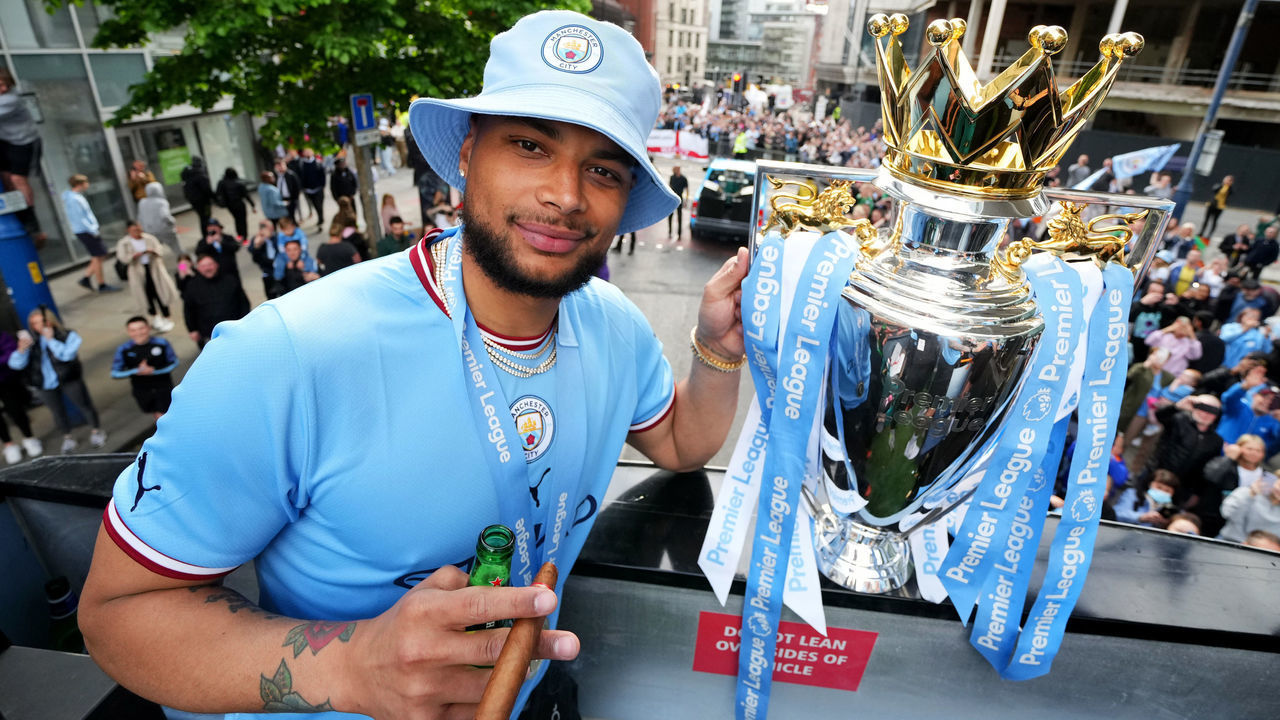 MANCHESTER, ENGLAND - MAY 23: Zack Steffen of Manchester City celebrates with the Premier League trophy on the parade bus during the Manchester City FC Victory Parade on May 23, 2022 in Manchester, England.