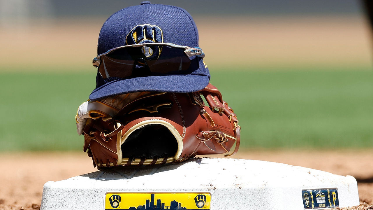 MILWAUKEE, WISCONSIN - JULY 10: A Brewers hat and glove sit on top of first base between innings during the game against the Pittsburgh Pirates at American Family Field on July 10, 2022 in Milwaukee, Wisconsin.
