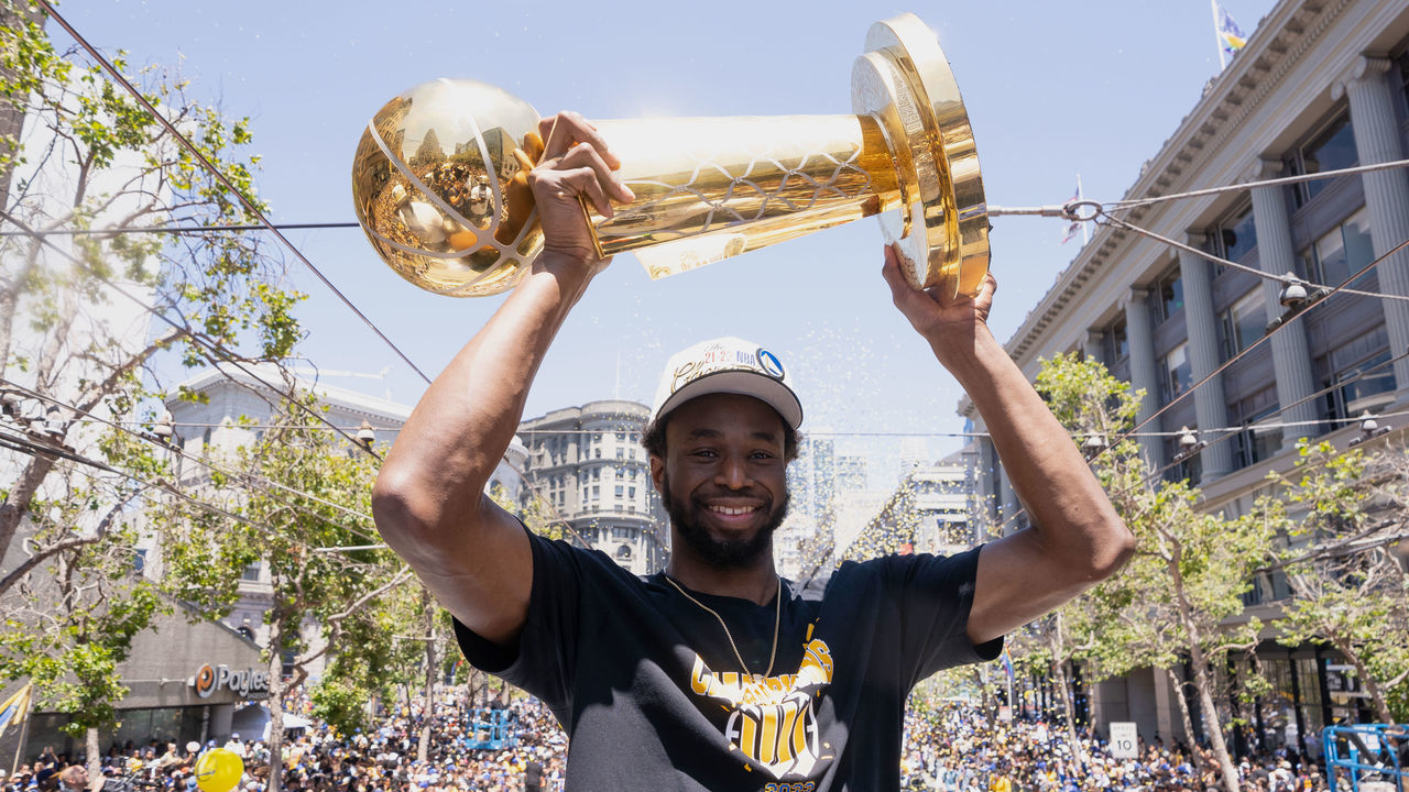 SAN FRANCISCO, CA - JUNE 20: Andrew Wiggins #22 of the Golden State Warriors smiles while holding the Larry OBrien Trophy during the 2022 Victory Parade & Rally on June 20, 2022 at Chase Center in San Francisco, California. NOTE TO USER: User expressly acknowledges and agrees that, by downloading and or using this photograph, user is consenting to the terms and conditions of Getty Images License Agreement. Mandatory Copyright Notice: Copyright 2022 NBAE