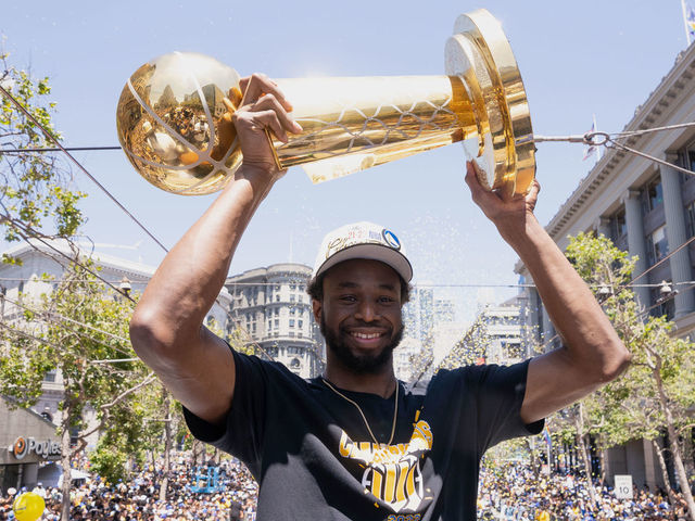 SAN FRANCISCO, CA - JUNE 20: Andrew Wiggins #22 of the Golden State Warriors smiles while holding the Larry OBrien Trophy during the 2022 Victory Parade & Rally on June 20, 2022 at Chase Center in San Francisco, California. NOTE TO USER: User expressly acknowledges and agrees that, by downloading and or using this photograph, user is consenting to the terms and conditions of Getty Images License Agreement. Mandatory Copyright Notice: Copyright 2022 NBAE