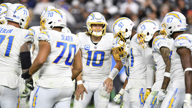 LAS VEGAS, NEVADA - JANUARY 09: Quarterback Justin Herbert #10 of the Los Angeles Chargers enters the huddle during the second half of a game against the Las Vegas Raiders at Allegiant Stadium on January 09, 2022 in Las Vegas, Nevada. The Raiders defeated the Chargers 35-32 in overtime.