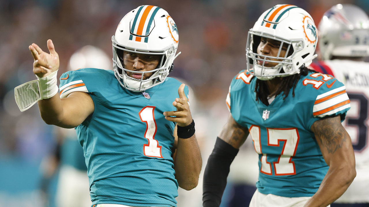 MIAMI GARDENS, FLORIDA - JANUARY 09: Tua Tagovailoa #1 of the Miami Dolphins celebrates a first down with Jaylen Waddle #17 against the New England Patriots during the fourth quarter at Hard Rock Stadium on January 09, 2022 in Miami Gardens, Florida.