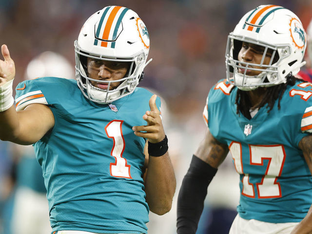 MIAMI GARDENS, FLORIDA - JANUARY 09: Tua Tagovailoa #1 of the Miami Dolphins celebrates a first down with Jaylen Waddle #17 against the New England Patriots during the fourth quarter at Hard Rock Stadium on January 09, 2022 in Miami Gardens, Florida.