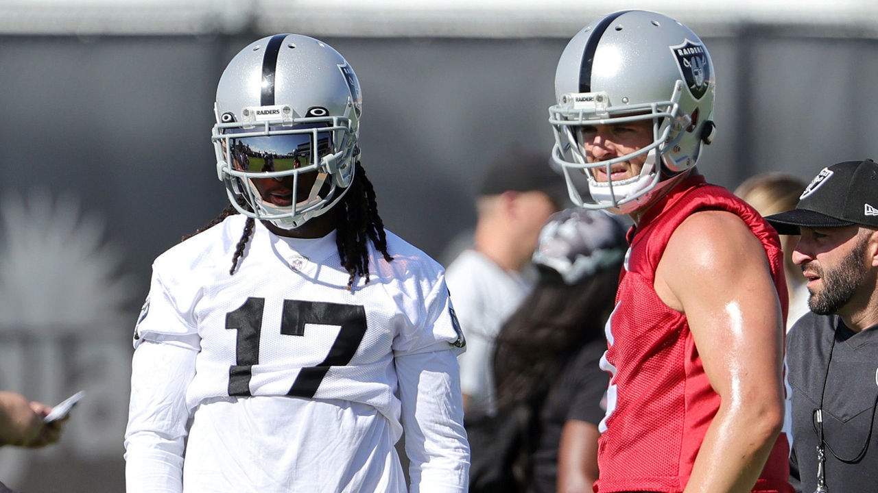 HENDERSON, NEVADA - JULY 24: (L-R) Head coach Josh McDaniels, wide receiver Davante Adams #17, quarterback Derek Carr #4 and offensive coordinator Mick Lombardi of the Las Vegas Raiders talk during training camp at the Las Vegas Raiders Headquarters/Intermountain Healthcare Performance Center on July 24, 2022 in Henderson, Nevada.