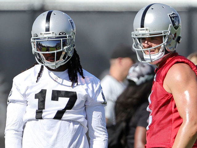 HENDERSON, NEVADA - JULY 24: (L-R) Head coach Josh McDaniels, wide receiver Davante Adams #17, quarterback Derek Carr #4 and offensive coordinator Mick Lombardi of the Las Vegas Raiders talk during training camp at the Las Vegas Raiders Headquarters/Intermountain Healthcare Performance Center on July 24, 2022 in Henderson, Nevada.