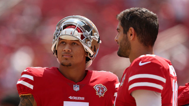 SANTA CLARA, CALIFORNIA - AUGUST 29: Jimmy Garoppolo #10 and Trey Lance #5 of the San Francisco 49ers talk to each other on the sidelines before their preseason game against the Las Vegas Raiders at Levi's Stadium on August 29, 2021 in Santa Clara, California.