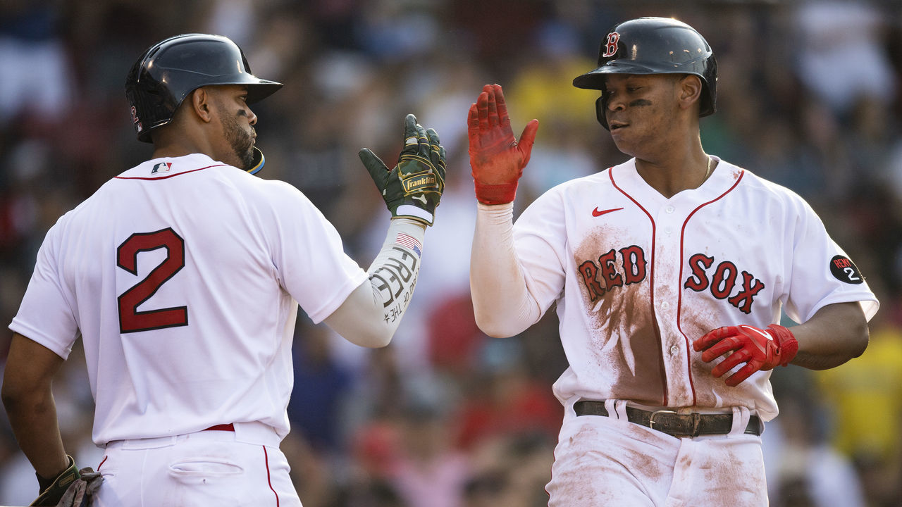 BOSTON, MA - MAY 21: Rafael Devers #11 of the Boston Red Sox reacts with Xander Bogaerts #2 after hitting a two-run home run during the fifth inning of a game against the Seattle Mariners on May 21, 2022 at Fenway Park in Boston, Massachusetts. It was his second home run of the game.