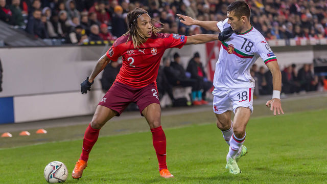 Lucerne, Switzerland - NOVEMBER 15: (BILD OUT) Kevin Mbabu of Switzerland and Ivaylo Chochev of Bulgaria battle for the ball during the 2022 FIFA World Cup Qualifier match between Switzerland and Bulgaria at Swissporarena on November 15, 2021 in Lucerne, Switzerland.