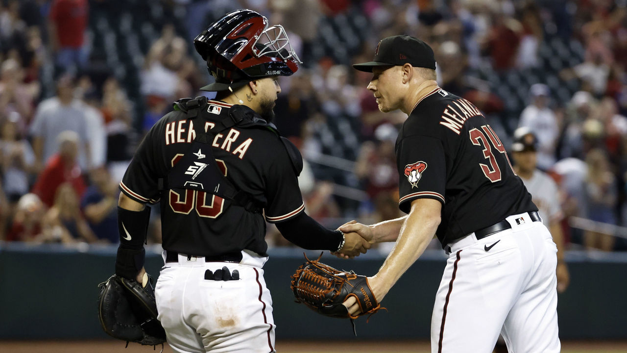 PHOENIX, ARIZONA - JULY 27: Mark Melancon #34 shakes hands with catcher Jose Herrera #36 of the Arizona Diamondbacks after the Diamondbacks beat the San Francisco Giants 5-3 at Chase Field on July 27, 2022 in Phoenix, Arizona.