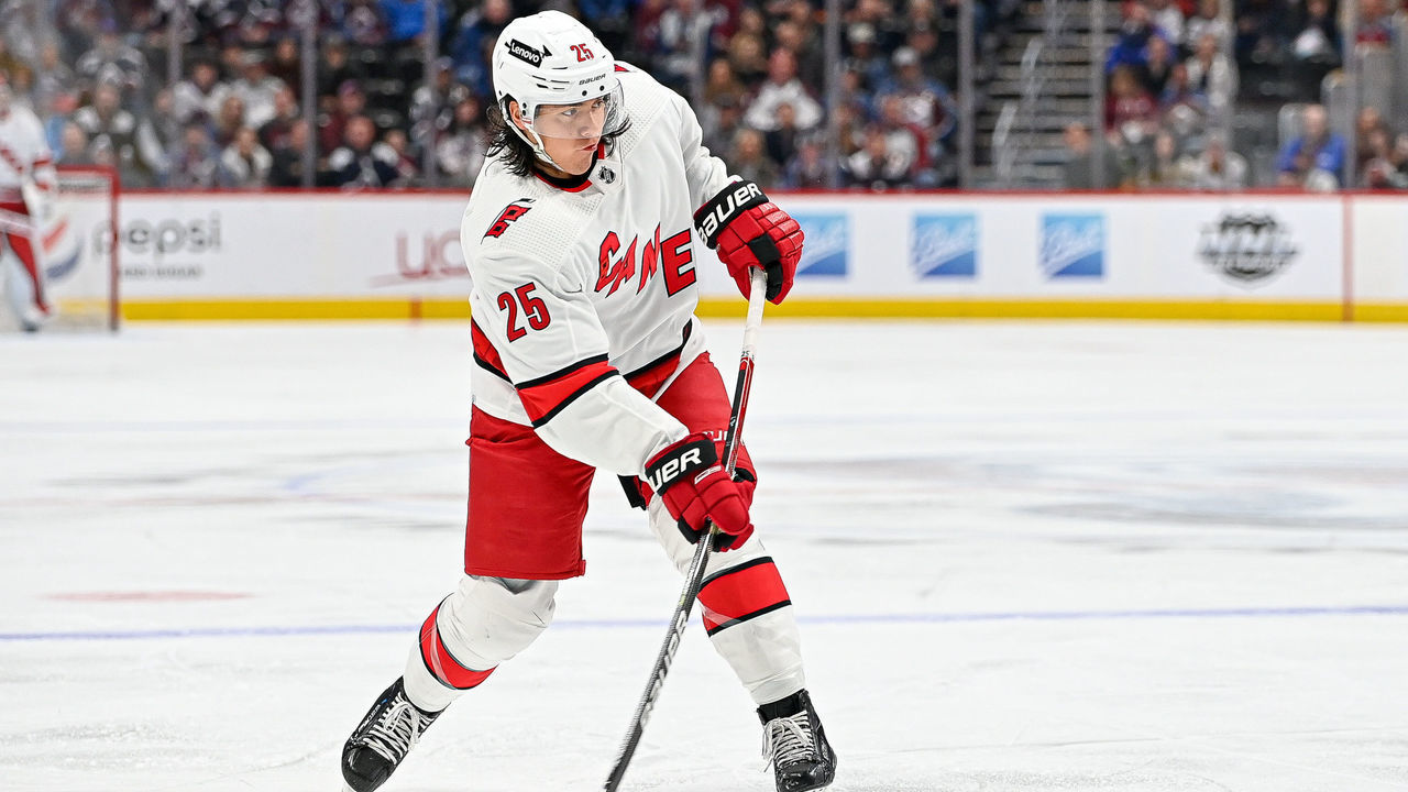 DENVER, COLORADO - APRIL 16: Ethan Bear #25 of the Carolina Hurricanes shoots against the Colorado Avalanche in the first period of a game at Ball Arena on April 16, 2022 in Denver, Colorado.