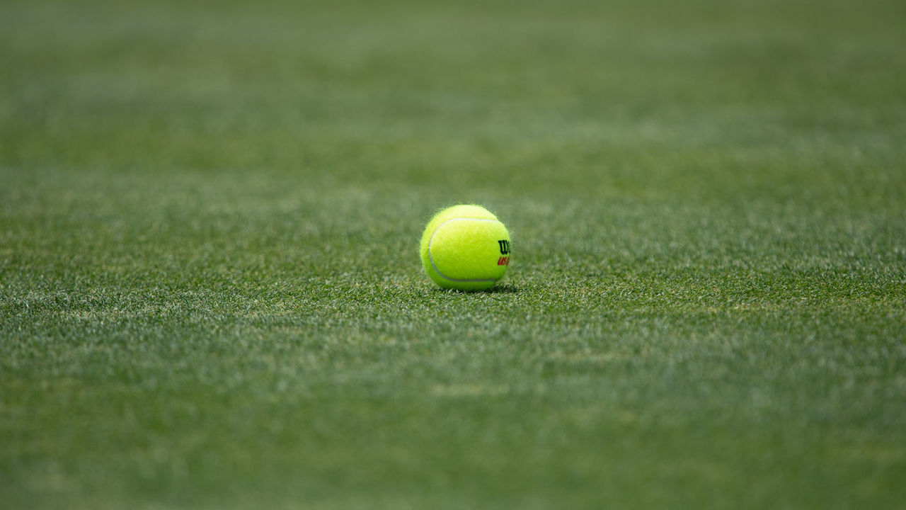 NEWPORT, RI - JULY 15: A general view of a tennis ball on the grass court during the Infosys Hall of Fame Open on July 15, 2022, at the International Tennis Hall of Fame in Newport, RI.