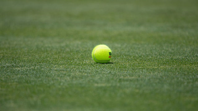NEWPORT, RI - JULY 15: A general view of a tennis ball on the grass court during the Infosys Hall of Fame Open on July 15, 2022, at the International Tennis Hall of Fame in Newport, RI.