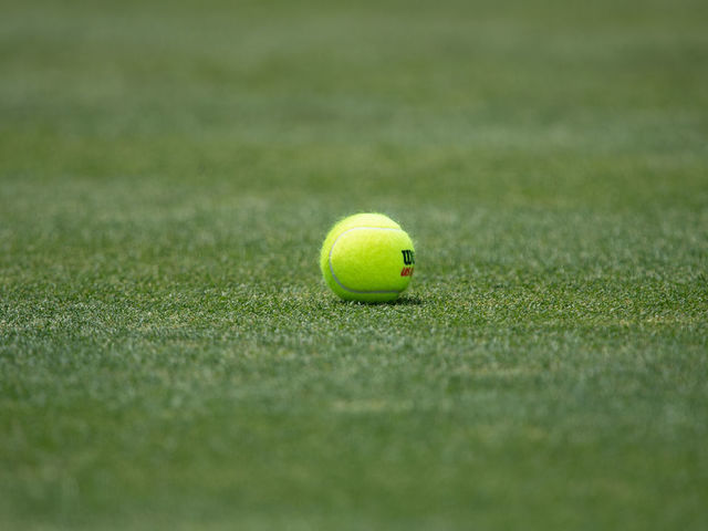 NEWPORT, RI - JULY 15: A general view of a tennis ball on the grass court during the Infosys Hall of Fame Open on July 15, 2022, at the International Tennis Hall of Fame in Newport, RI.