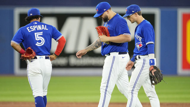 TORONTO, ON - JULY 29: Alek Manoah #6 of the Toronto Blue Jays walks around in a break in play after being hit with a ball with teammates Cavan Biggio #8 and Santiago Espinal #5 against the Detroit Tigers in the sixth inning during their MLB game at the Rogers Centre on July 29, 2022 in Toronto, Ontario, Canada.
