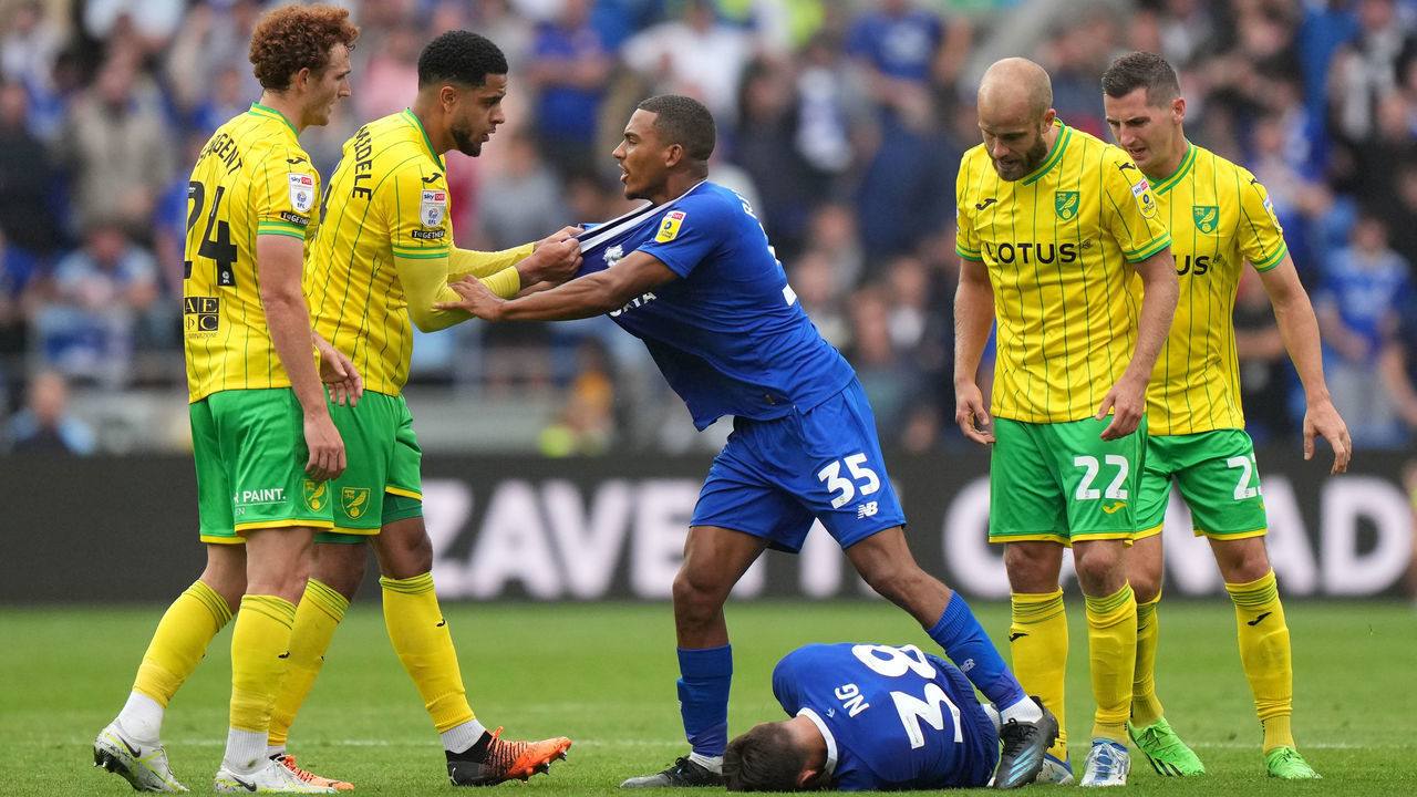 Norwich City's Andrew Omobamidele clashes with Cardiff City's Andy Rinomhota as Perry Ng lies on the floor during the Sky Bet Championship match at the Cardiff City Stadium. Picture date: Saturday July 30, 2022.