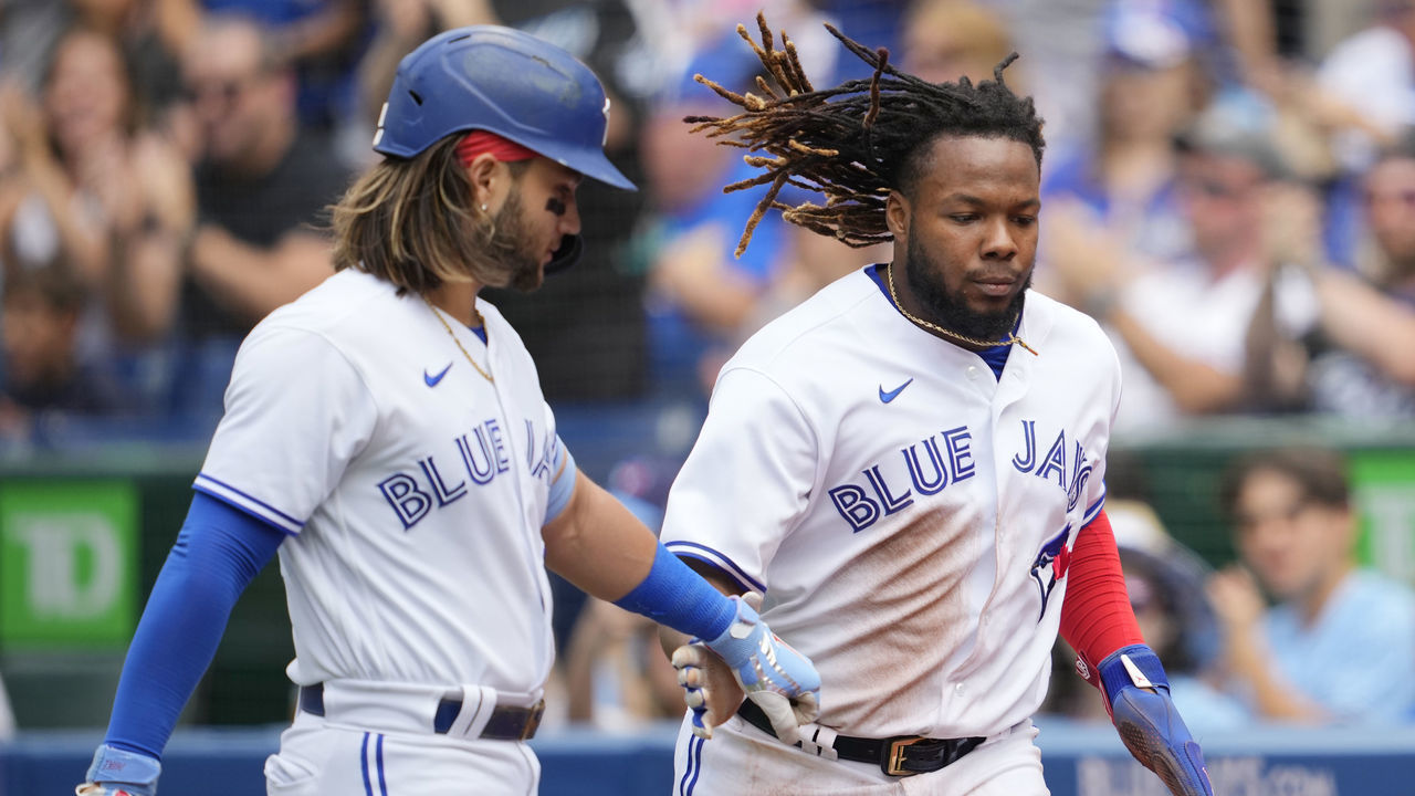 TORONTO, ON - JULY 30: Vladimir Guerrero Jr. #27 of the Toronto Blue Jays celebrates scoring with Bo Bichette #11 against the Detroit Tigers in the fist inning during their MLB game at the Rogers Centre on July 30, 2022 in Toronto, Ontario, Canada.