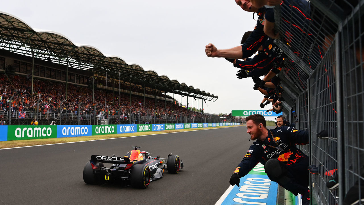 BUDAPEST, HUNGARY - JULY 31: Race winner Max Verstappen of the Netherlands driving the (1) Oracle Red Bull Racing RB18 passes his team celebrating on the pitwall during the F1 Grand Prix of Hungary at Hungaroring on July 31, 2022 in Budapest, Hungary.