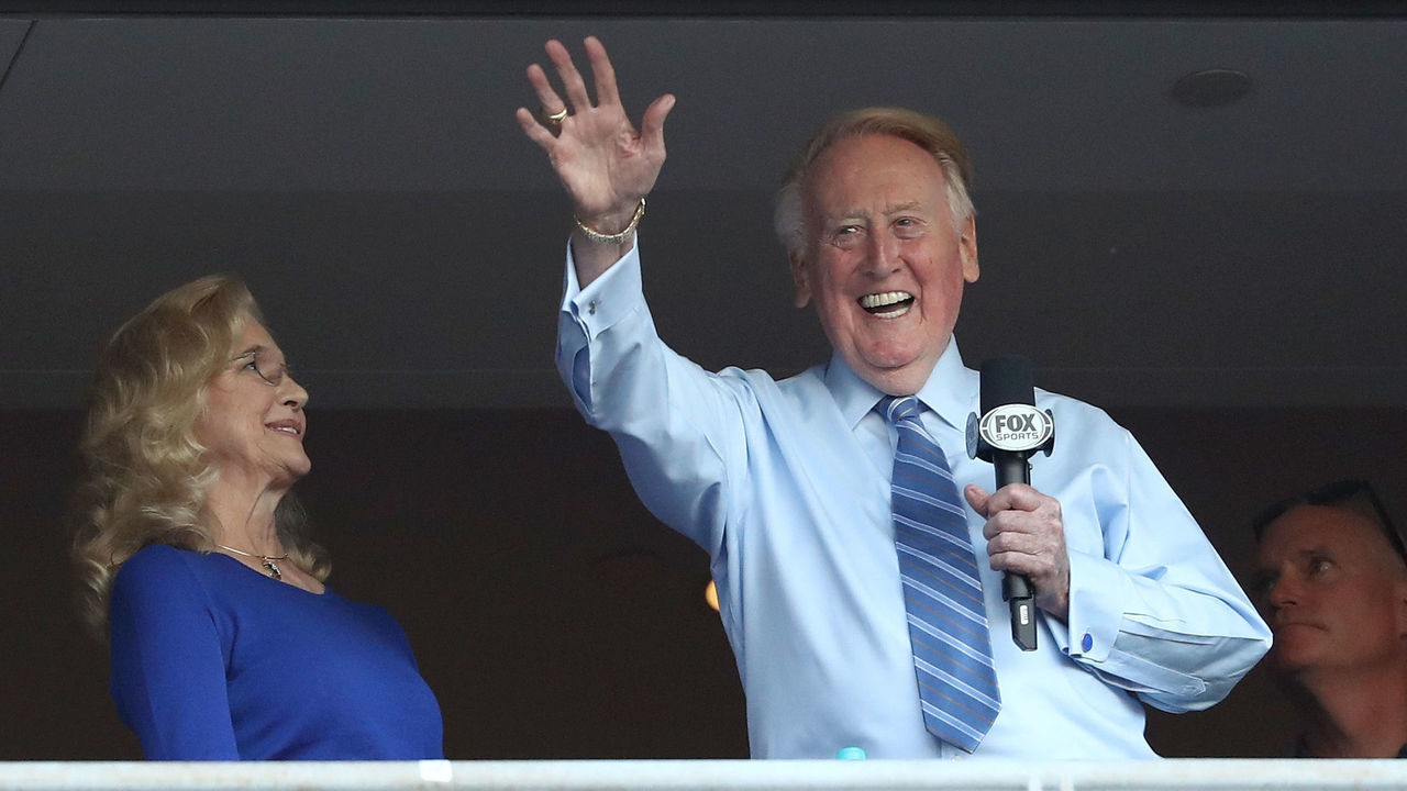 LOS ANGELES, CA - OCTOBER 20: Los Angeles Dodgers broadcaster Vin Scully waves to the crowd alongside his wife Sandra Hunt before the Dodgers take on the Chicago Cubs in game five of the National League Division Series at Dodger Stadium on October 20, 2016 in Los Angeles, California.