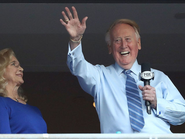 LOS ANGELES, CA - OCTOBER 20: Los Angeles Dodgers broadcaster Vin Scully waves to the crowd alongside his wife Sandra Hunt before the Dodgers take on the Chicago Cubs in game five of the National League Division Series at Dodger Stadium on October 20, 2016 in Los Angeles, California.