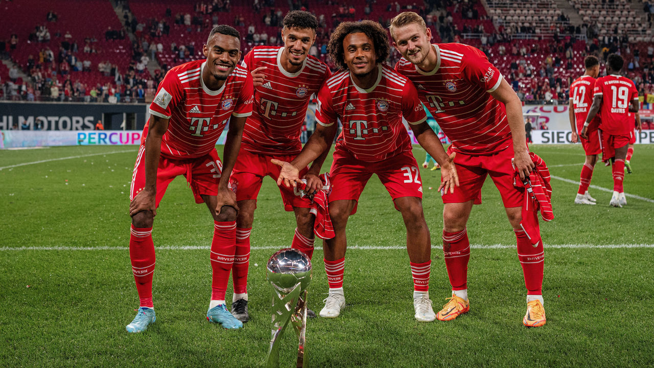 LEIPZIG, GERMANY - JULY 30: (L-R) Ryan Gravenberch, Noussair Mazraoui, Joshua Zirkzee and Matthijs de Ligt of FC Bayern Muenchen pose with the winners trophy after winning the Supercup 2022 match between RB Leipzig and FC Bayern München at Red Bull Arena on July 30, 2022 in Leipzig, Germany.